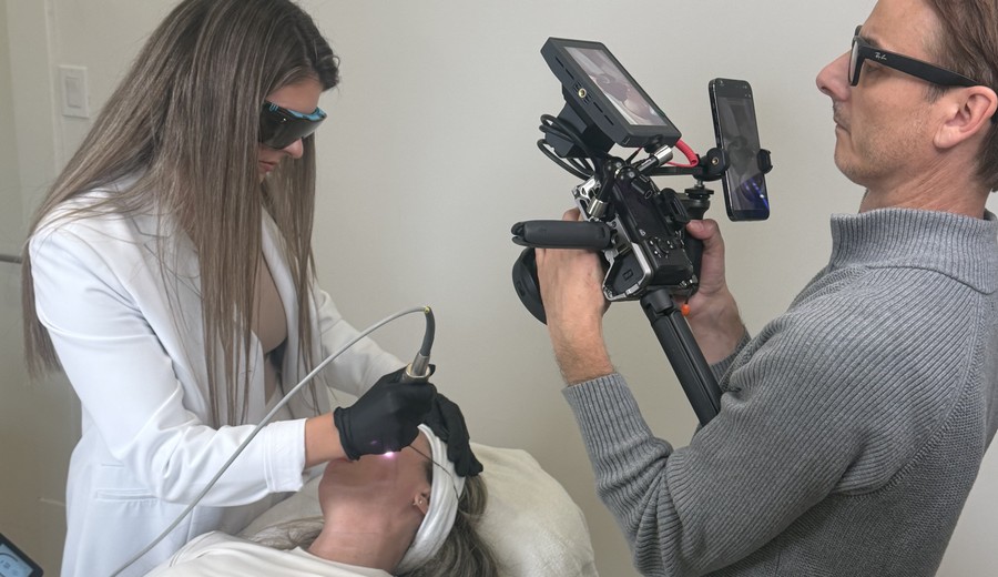 Social Medispa filming a laser treatment on location at a med spa, camera rig in hand while the injector works